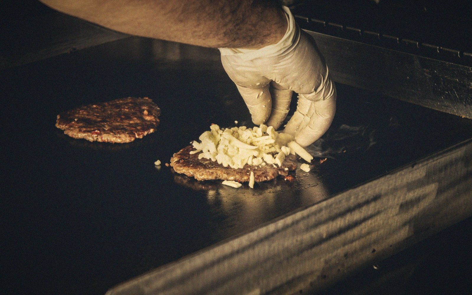 Hands forming a patty loosely on a board